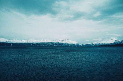 Scenic view of mountains against cloudy sky