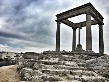 Low angle view of historical building against cloudy sky