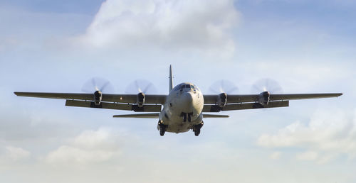 Low angle view of airplane flying against sky