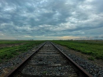 View of railroad track against cloudy sky