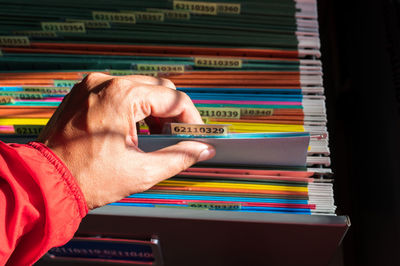 Close-up of hand on book