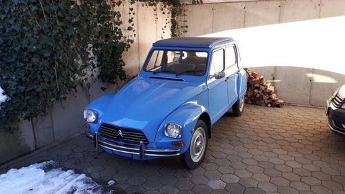 Vintage car on street against wall