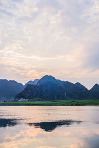 Scenic view of lake against sky during sunset