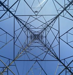 Low angle view of electricity pylon against clear sky