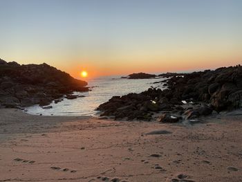 Scenic view of sea against clear sky during sunset