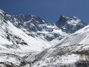 Scenic view of snowcapped mountains against clear sky