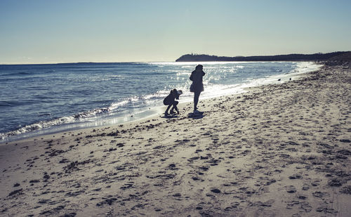 People on beach against sky