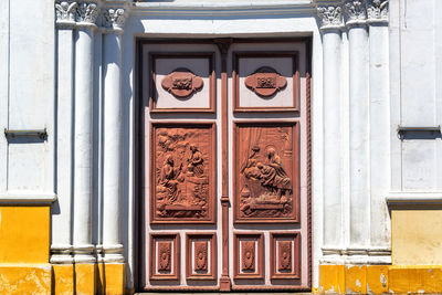 Entrance of san sebastian church in city on sunny day