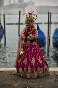 Person wearing costume while standing against sea