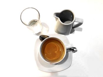 High angle view of coffee cup over white background