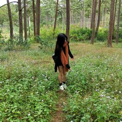 Woman walking in forest