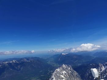 Scenic view of mountains against blue sky