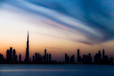 View of city at waterfront during sunset