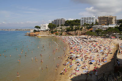 High angle view of buildings by sea against sky