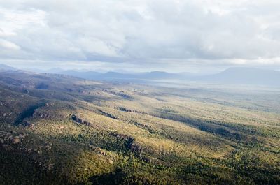 Scenic view of mountains against cloudy sky