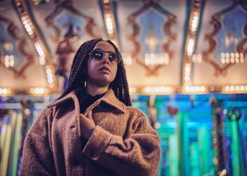 Young woman with dreadlocks wearing sunglasses