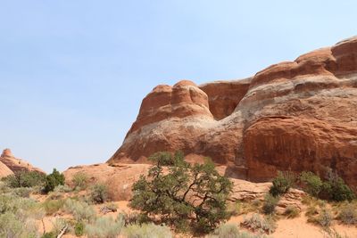 Low angle view of rock formations at arches national park against sky