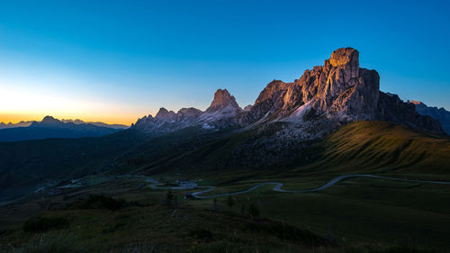 Scenic view of mountains against blue sky