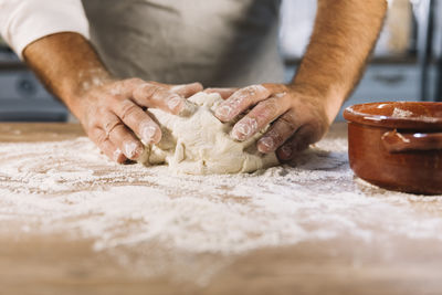 Cropped hands of chef preparing food