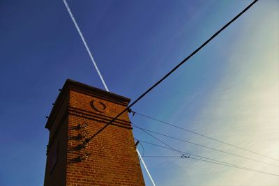 Low angle view of power lines against blue sky