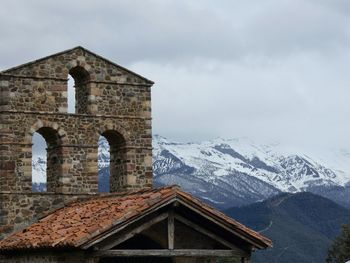 Houses against snowcapped mountains