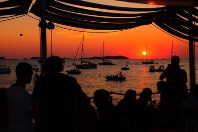 Silhouette of boat in sea at sunset