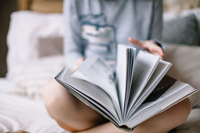 Close-up of hand holding book