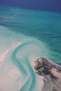 Aerial view of beach against blue sky