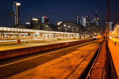 Light trails on railroad station platform at night