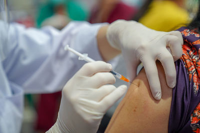 Doctor filling syringe with covid-19 vaccine doctor or scientist in the covid-19 medical vaccine 