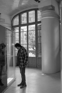 Man and woman standing by window in building