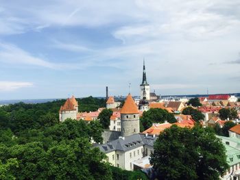 Panoramic view of buildings and trees against sky