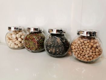 Various fruits in jar on table