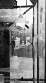 Reflection of building on wet glass window