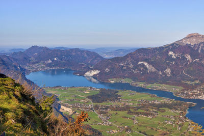 High angle view of lake and mountains against sky