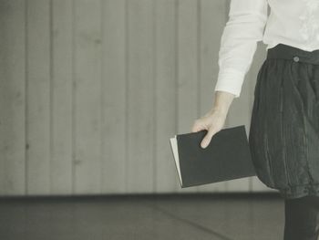 Low section of woman standing on tiled floor