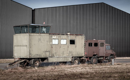 Abandoned truck on field against sky