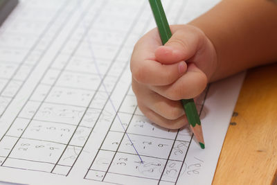 Close-up of hand holding paper