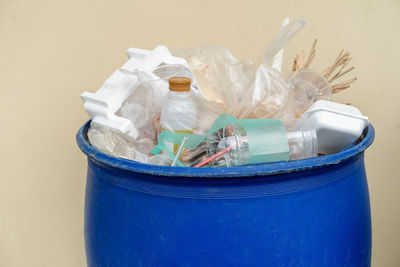 Close-up of garbage bin against white background