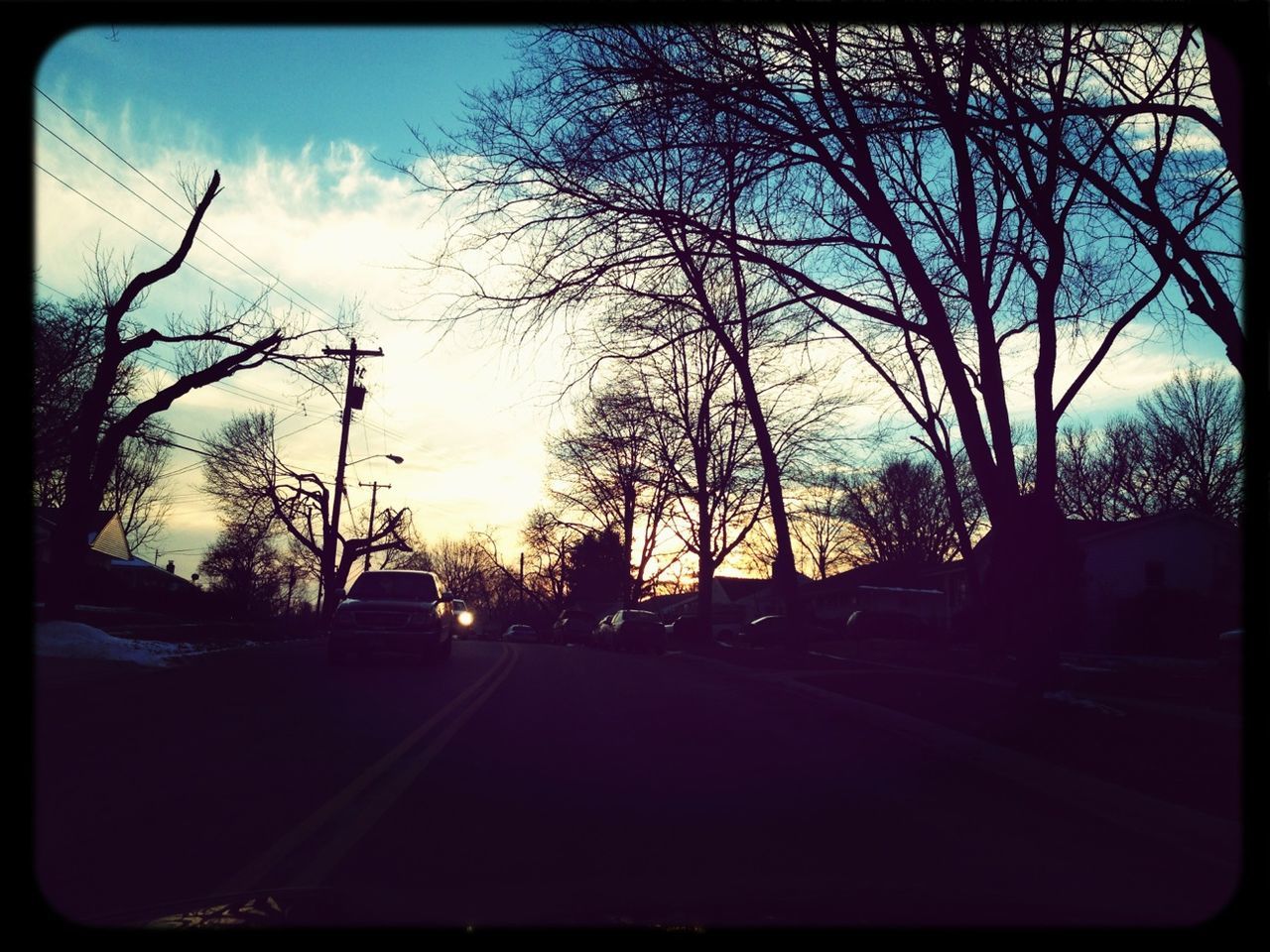 transportation, transfer print, tree, road, sky, car, the way forward, auto post production filter, land vehicle, silhouette, cloud - sky, street, diminishing perspective, road marking, bare tree, cloud, sunset, mode of transport, sunlight, no people