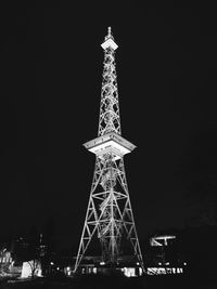 Low angle view of illuminated tower against sky at night