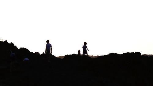 Silhouette man against clear sky at sunset