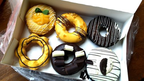 High angle view of donuts in box on table