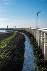 View of bridge over sea against blue sky