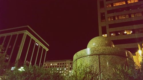 Low angle view of modern building against sky at night