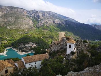 Scenic view of buildings and mountains against sky