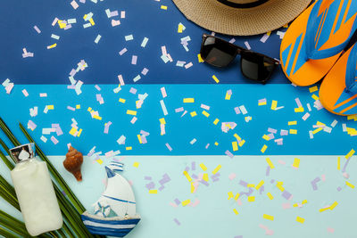 Directly above view of confetti and objects on table