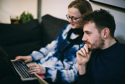 Young man using mobile phone at home
