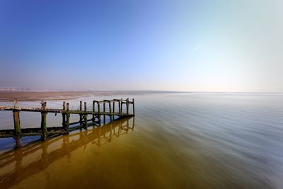 Pier over sea against clear sky