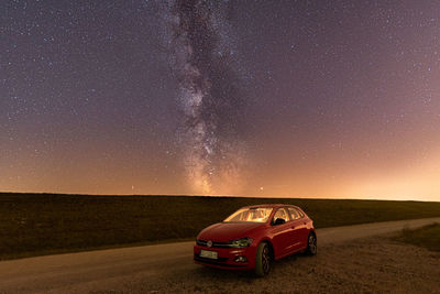 Vintage car on land against sky at night